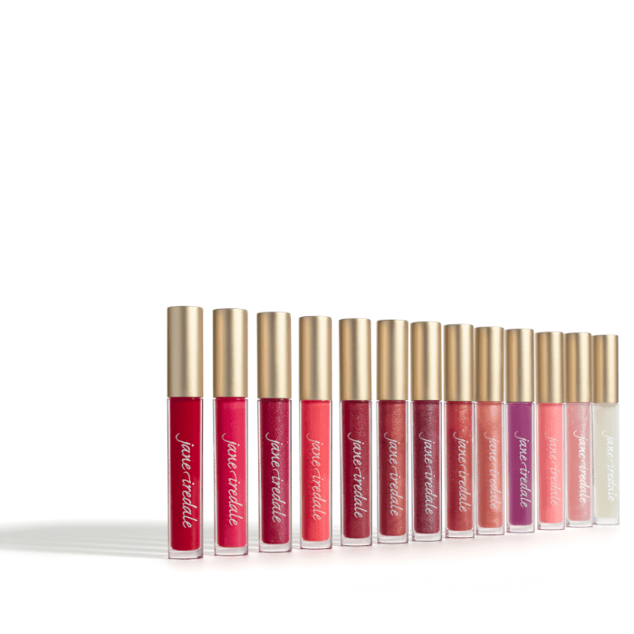 Na przesłanym zdjęciu widzimy pełną linię błyszczyków Jane Iredale HydroPure Hyaluronic Lip Gloss. Każdy z nich ma wyjątkowy kolor i wykończenie – od transparentnych, przez delikatne róże i brzoskwinie, aż po intensywne czerwienie i burgundy.