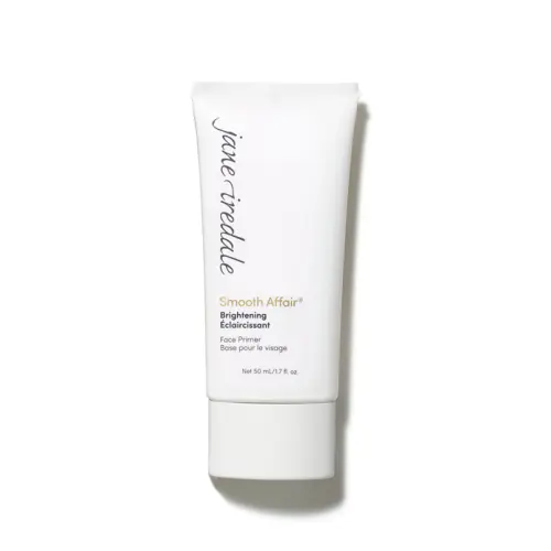 Na zdjęciu znajduje się biała tubka bazy pod makijaż Jane Iredale Smooth Affair Brightening Face Primer. Na niej czarno – złote napisy z nazwą produktu. Produkt rozświetla i wygładza skórę i przygotowuje ją do aplikacji makijażu.