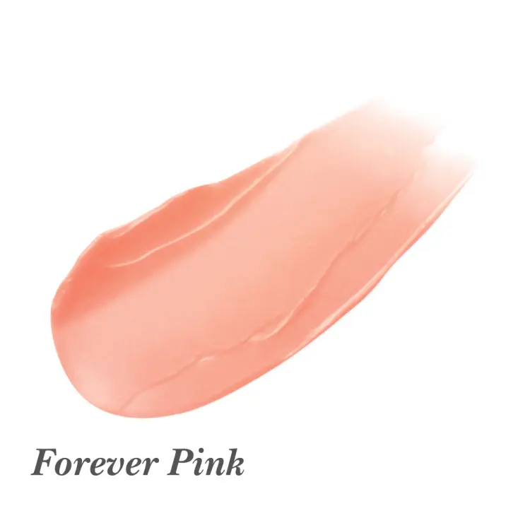 Na zdjęciu przedstawiono próbkę koloru produktu do ust i policzków Jane Iredale Just Kissed Lip and Cheek Stain w odcieniu Forever Pink.  Kolor ma formę delikatnie błyszczącego, półprzezroczystego różu o ciepłym tonie