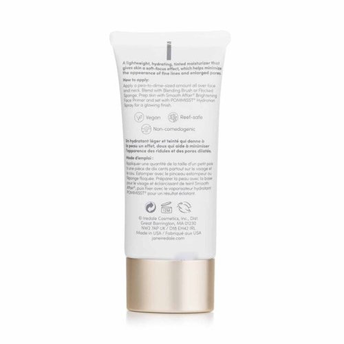 Tył opakowania JANE IREDALE Dream Tint Tinted Moisturizer to elegancka tubka z miękkiego plastiku w kolorze beżowym, z delikatnymi złotymi akcentami. Ma praktyczny otwór dozujący, umożliwiający łatwą aplikację. Pojemność to 40 ml.