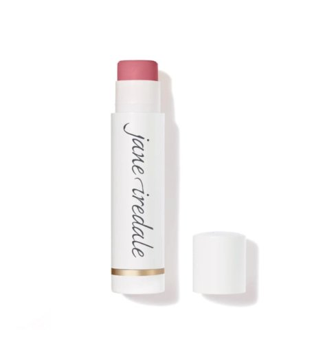 Na zdjęciu znajduje się balsam do ust marki jane iredale Lip Drink. Produkt ma eleganckie, białe opakowania z logo marki i złotym akcentem przy podstawie.