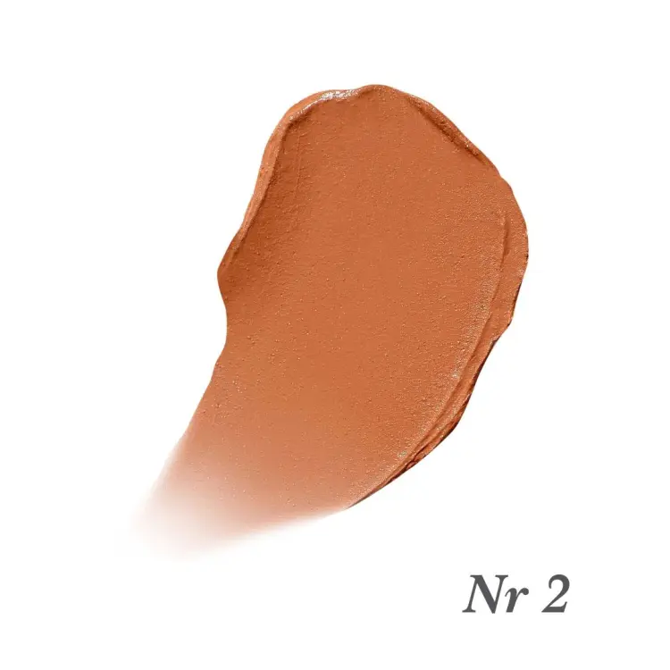 Na zdjęciu jest próbka korektora Jane Iredale Enlighten Concealer. Próbka ma ciepły, beżowo-brzoskwiniowy odcień.