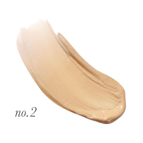 Na zdjęciu przedstawiono odcień korektora Jane Iredale Active Light oznaczony jako No. 2. Odcień został pokazany w formie rozsmarowanej próbki, co pomaga ocenić kolor i konsystencję produktu. No. 2 to jasny beż z cieplejszym tonem.